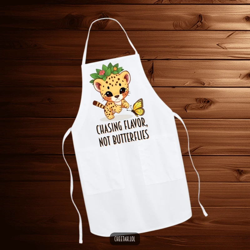 Funny cheetah cub wearing a leaf crown, playfully pouncing on a butterfly, illustrated on a kitchen apron for a humorous cooking experience.