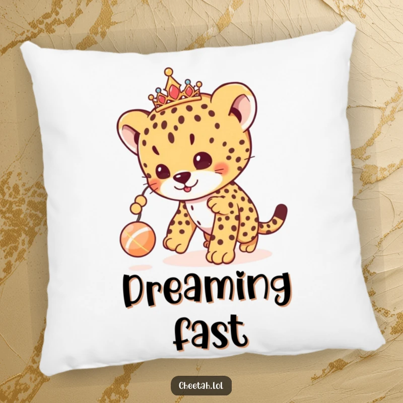 Funny cheetah cub pillow featuring a regal cub with a tiara, playfully chasing a toy, offering cute and cozy comfort.