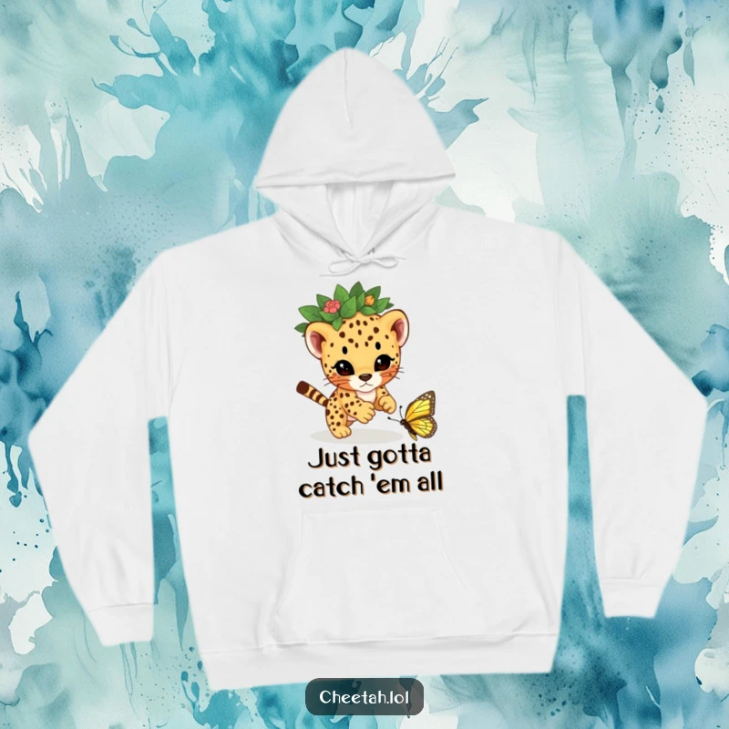 Funny cheetah cub wearing a leaf crown, energetically pouncing on a butterfly, captured on a cozy hoodie for maximum comfort and humor.