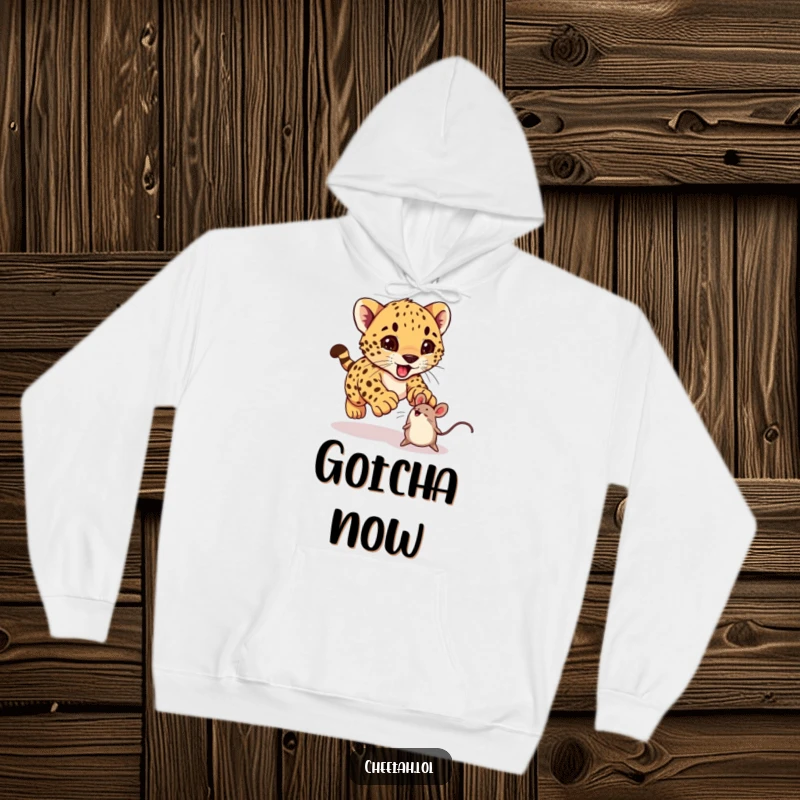 Funny cheetah cub excitedly pouncing on a bouncing toy mouse on a hoodie, perfect for cozy, cheerful wear.