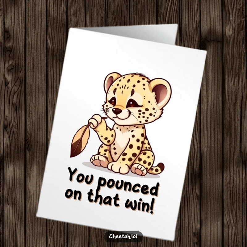 Funny Free Printable Congrats Card: A cheetah cub playfully bats at a feather, celebrating a fun win.