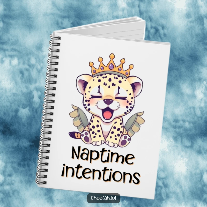 Funny sleepy cheetah cub wearing a feathered crown, yawning on this notebook, inspiring cozy thoughts.
