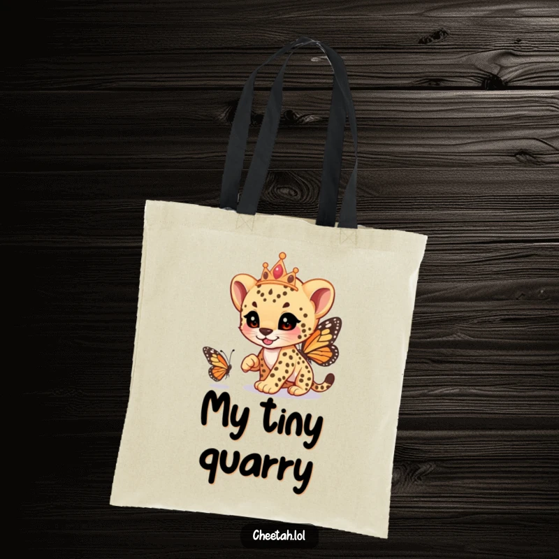 Funny cheetah cub wearing a tiara, playfully racing a butterfly, on a sturdy tote bag, carrying whimsy, a funny gift.