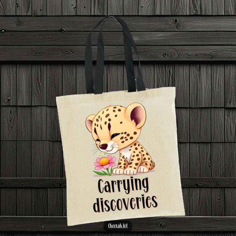 Funny cheetah cub wonder tote bag featuring a curious cub smelling a flower, perfect for carrying items with charm and humor.