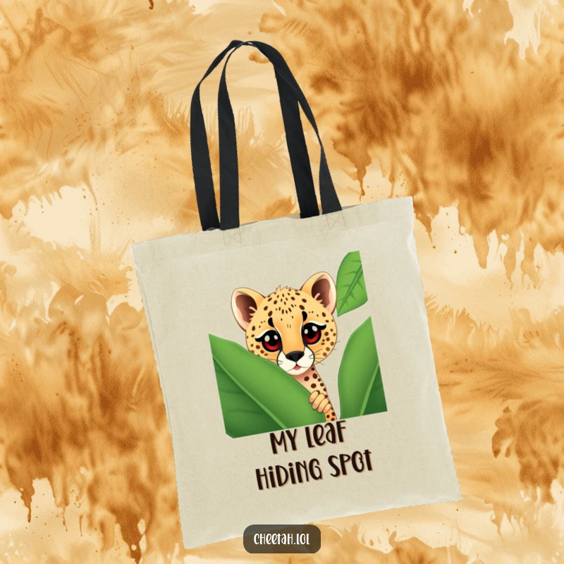 Funny cheetah with large, curious eyes peeking out from behind a giant spotted leaf, printed on a durable tote bag.